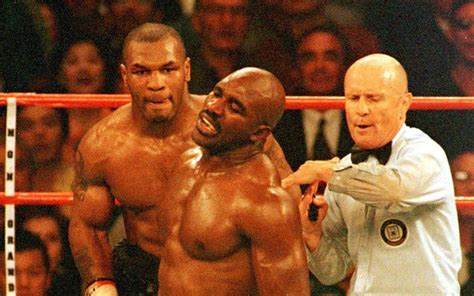 Download Evander Holyfield Assessed By Referee Wallpaper