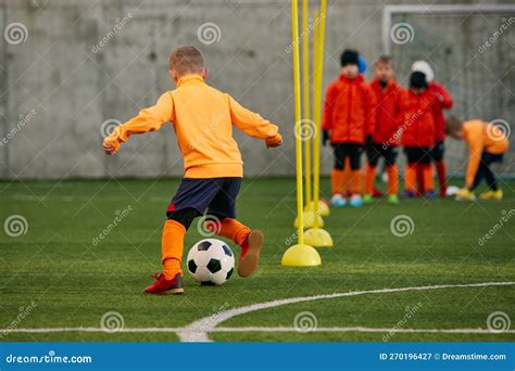 Little Boy Child Football Player In Uniforma Training Outdoor At