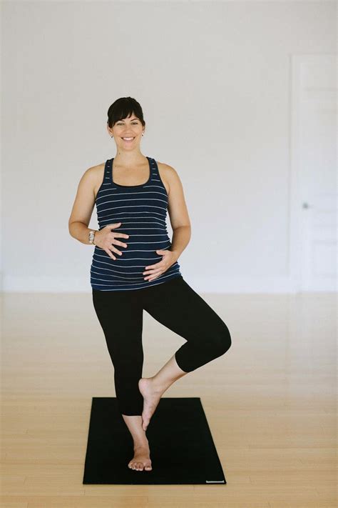 A Woman Is Standing On A Yoga Mat