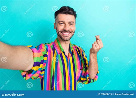 Portrait Of Toothy Beaming Optimistic Guy With Brunet Haircut Wear Colorful Shirt Showing Heart