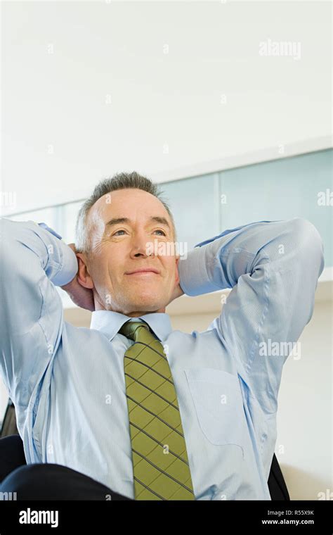 Businessman With Hands Behind His Head Stock Photo Alamy