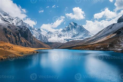 Tranquil Blue Lake Surrounded By Snow Capped Mountains Stock