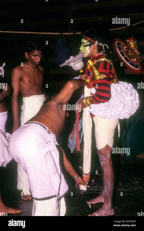 Koodiyattam Kodiyattom actor being fitted with his costume, which is ...