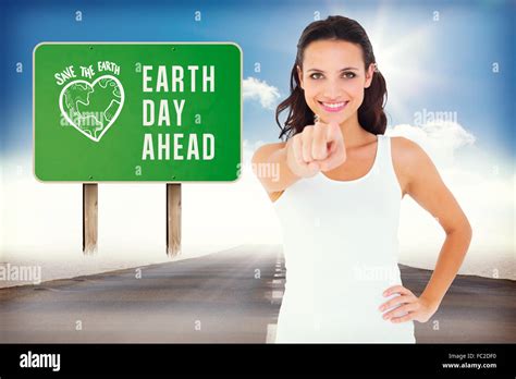 Composite Image Of Pretty Brunette Pointing With Finger Stock Photo Alamy
