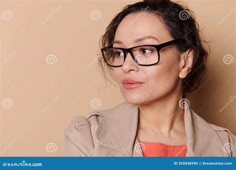 Close Up Portrait Of Beautiful Middle Aged Woman Wearing Stylish Eyeglasses Looking Away At Ad