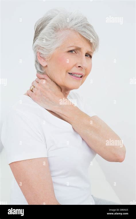 Side View Portrait Of A Senior Woman Suffering From Neck Pain Stock