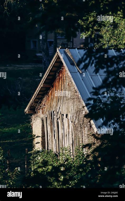 Old Wooden Barn In The Village For Storing Hay And Firewood Stock Photo