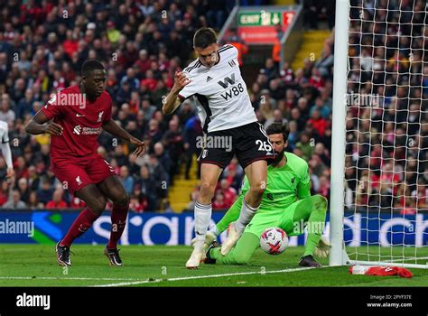 Liverpool goalkeeper Alisson Becker saves a back heel from Fulham’s Joao Palhinha during the ...