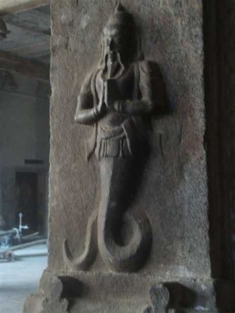 an ancient statue is displayed on the wall