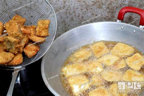 Cooking deep fried tempeh, Indonesian traditional meal, tempe goreng or ...