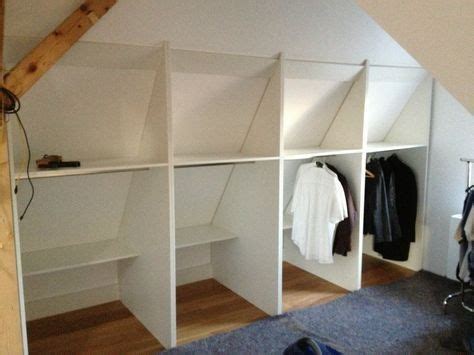 An Attic Bedroom With White Shelving And Wood Flooring