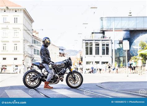 Cool Looking Motorcycle Rider On Custom Made Scrambler Style Cafe Racer