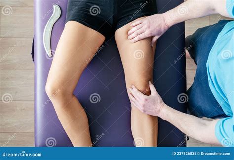 Osteopath Performing Myofascial Release For Quadriceps Stock Image