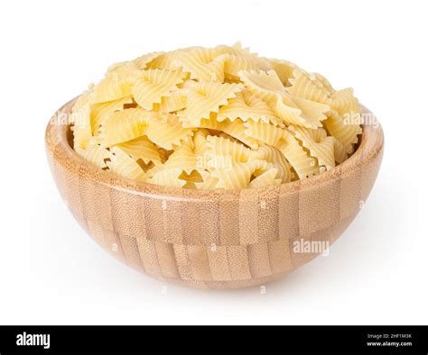 Uncooked Dried Bow Tie Pasta In Wooden Bowl Isolated On White