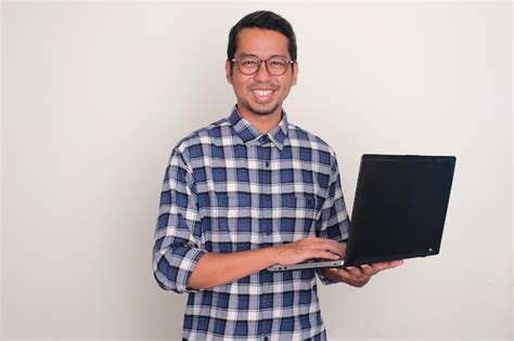 Premium Photo Adult Asian Man Smiling Confident While Holding A Laptop