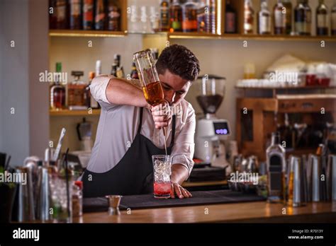 Barman pouring drink Stock Photo - Alamy