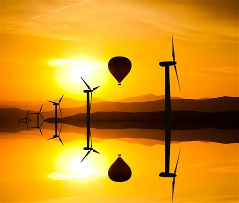 Premium Photo Silhouette Of Wind Turbines And A Hot Air Balloon On The Background Of Mountains