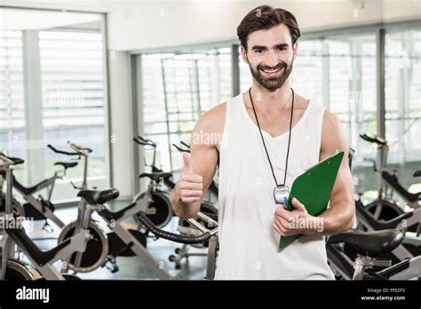 Smiling Trainer Showing Thumb Up Stock Photo Alamy