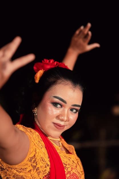 Premium Photo An Asian Traditional Dancer In An Orange Dress With A Red Scarf And Makeup