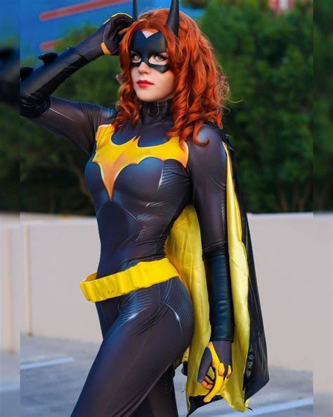 A Woman Dressed As Batgirl Posing For The Camera