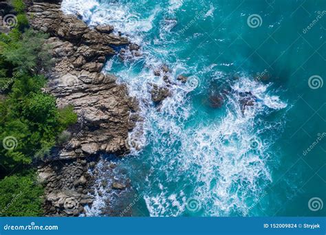 Aerial Top View Of Ocean S Beautiful Waves Crashing On The Rocky Island