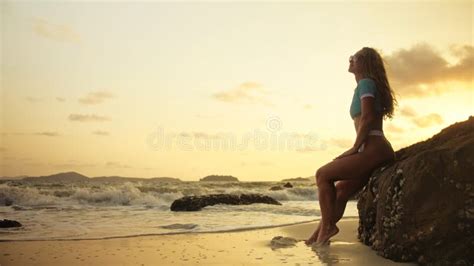 Woman Leaning On A Rock Reef Enjoying The Warm Golden Sunset Wo Stock Image Image Of Golden