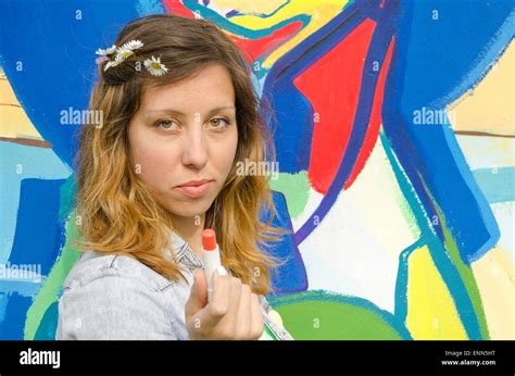 Brunette Girl Posing Against A Colorful Backdrop Holding Lipstick Stock Photo Alamy