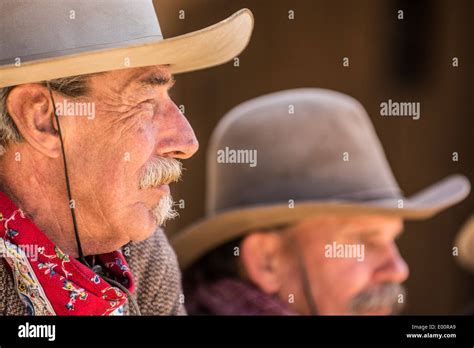 Two Middle Aged Cowboys Looking Out Over The Town Stock Photo Alamy