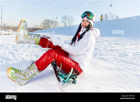 Brunette With Snowboard On Snow Stock Photo Alamy