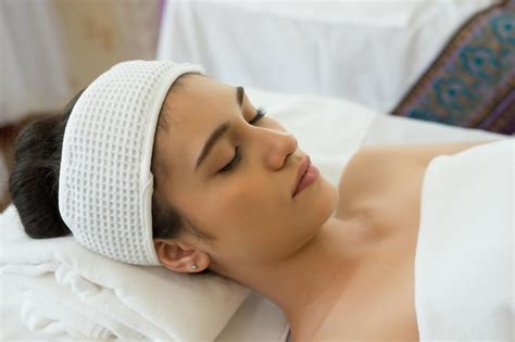 Premium Photo Young Woman With Eyes Closed Lying On Massage Table