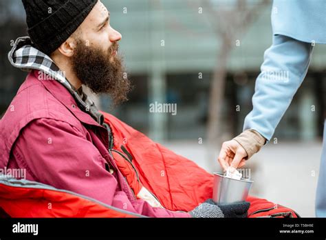 Woman Giving Some Money For A Homeless Beggar Close Up View Concept