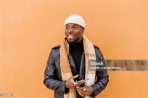 Cheerful Bearded African American Male Wearing Leather Jacket Scarf And