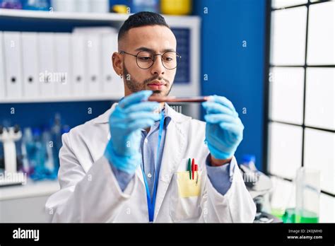 African American Man Scientist Holding Blood Test Tube At Laboratory