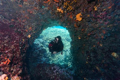 Scuba Diver Admiring Corals That Covered Underwater Swim Trough By