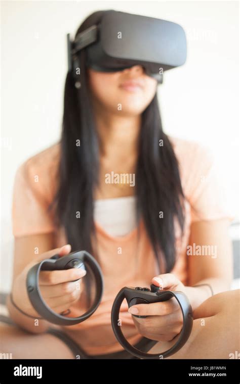 Young Woman Wearing Augmented Reality Oculus Rift Virtual Reality