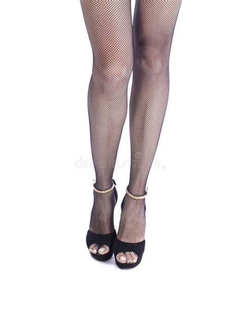 Female Legs In High Heel Black Shoes And Fishnet Stockings Retro Style