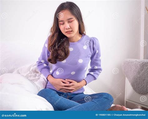 A Woman Has An Upset Stomach Tense With A Hand By Pressing The Stomach Menstrual Cramps Stock