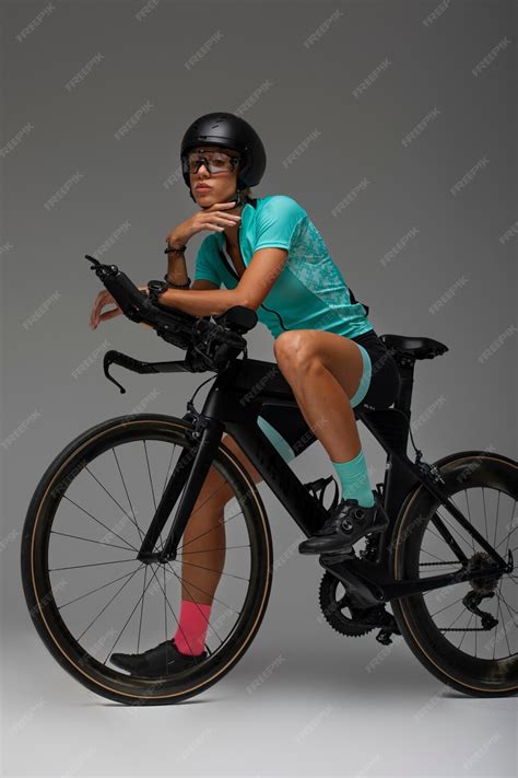 Free Photo Female Cyclist Wearing Helmet And Posing With Bicycle