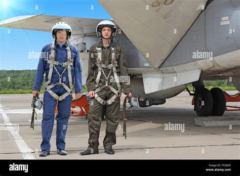 Two military pilot in a helmet near the aircraft Stock Photo - Alamy