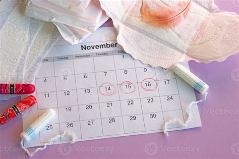 Menstrual Pads And Tampons On Menstruation Period Calendar With On Lilac Background 36037882