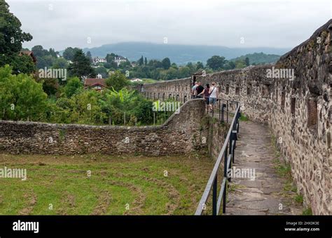 Tourists Walking The Old Town Walls Of St Jean Pied De Port In France
