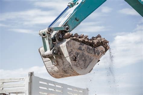 Premium Photo | Working excavator tractor digging a trench.