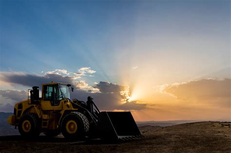 Loader Excavator Working At Sunset Stock Photo Download Image Now