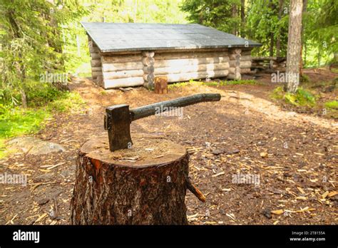 A Free Axe Is Left In A Chopping Block For Hikers To Use At A Wooden Shelter On A Hiking Trail