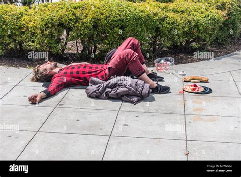 Homeless Person Passed Out On The Sidewalk Spread Eagle With His Arms Spread Out From His Side