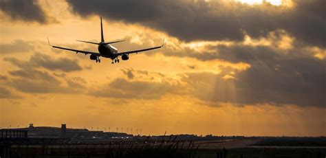 Premium Photo Airplane Flying In Orange Sky