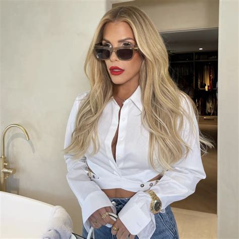 Tracy Tutor’s White Belted Cropped Shirt And Clear Sunglasses Big Blonde Hair