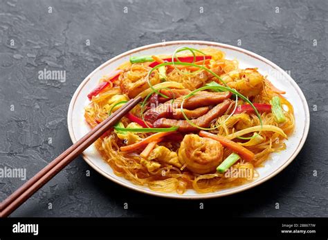 Singapore Mei Fun In White Plate On Dark Slate Background Singapore Noodles Is Chinese Cuisine