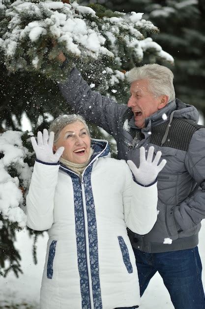 Premium Photo Happy Senior Couple At Snowy Winter Park