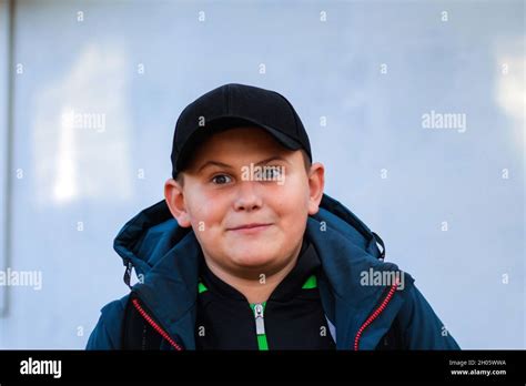 Portrait Of Preteen Surprised Happy Boy Close Up In Jacket And Cap